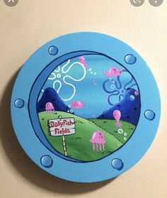 a blue clock with an image of jellyfish on it's face and the words baby pink fields