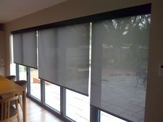 a dining room with large sliding glass doors