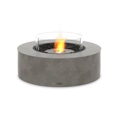 a concrete fire pit with flames burning inside