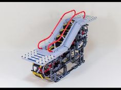 a lego model of a roller coaster with red and yellow rails on it's sides