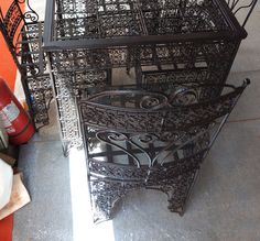 three wrought iron tables sitting next to each other