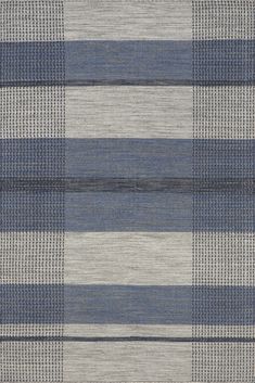 an area rug with blue and grey stripes