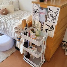 a bedroom with a bed, dresser and other items on the floor next to it