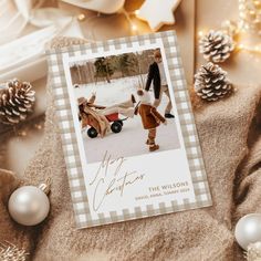 a christmas card with an image of a man pushing a wagon