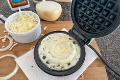 a waffle iron with cream cheese and other ingredients