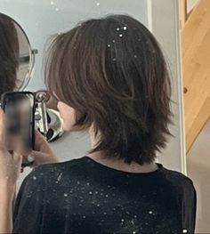 a woman taking a selfie in front of a mirror