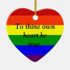 a rainbow heart ornament with the words to thine own heart be true