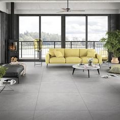 a living room filled with furniture and large windows