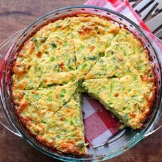 a quiche with broccoli and cheese in a glass pie dish on a table