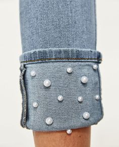 a woman's legs with pearls on them and her leg in the shape of a pair of jeans