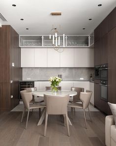 a dining room table with chairs and a vase on it in front of an oven