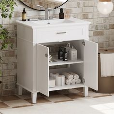 a white bathroom sink sitting under a mirror