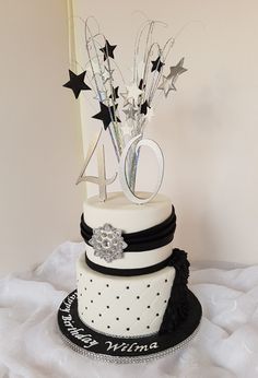 a white and black cake with stars on top