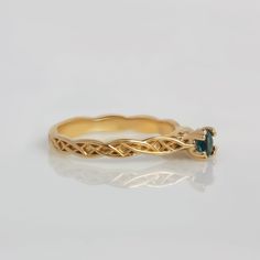 a gold ring with a blue stone in it