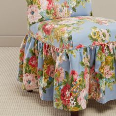 a blue floral chair with a flowered skirt on it