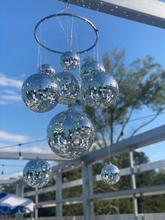 several disco balls hanging from a metal pole