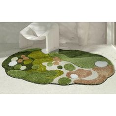 a green rug on the floor in a bathroom