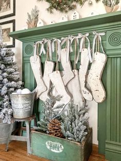 stockings hung on the mantle in front of a christmas tree