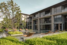 an artist's rendering of a modern building with pool and lounge chairs in the foreground