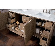 a bathroom vanity with two sinks and several drawers in it's cabinetry area