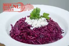 a white plate topped with red cabbage and feta cheese