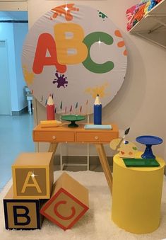 children's toys are arranged on the floor in front of a large abc sign