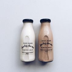 two bottles of almond milk sitting next to each other