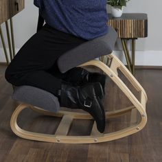 a person sitting in a rocking chair on the floor