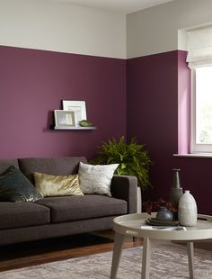 a living room with purple walls and white trim on the walls is featured in an instagram