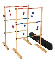 two wooden ladders with balls on them and a black bag next to it that says new