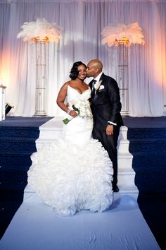 a bride and groom pose for a photo on their wedding day