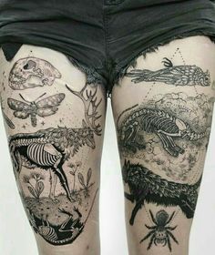 a woman's legs with tattoos on them and some animals in the water behind her