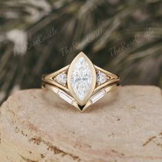 a close up of a ring on top of a rock with leaves in the background