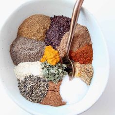 a white bowl filled with different types of spices