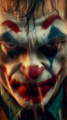 a close up of a clown's face in the rain