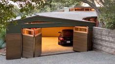 a car is parked in the garage with its door open