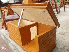 an open wooden box sitting on the ground