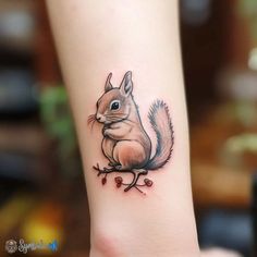 a small squirrel tattoo on the ankle