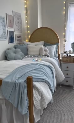 a bed sitting in a bedroom next to a window with string lights on the wall