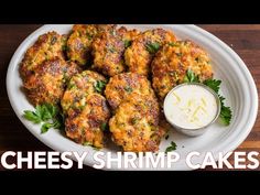 cheesey shrimp cakes on a plate with ranch dressing