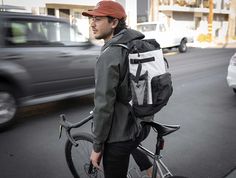 a man with a backpack and bicycle on the street