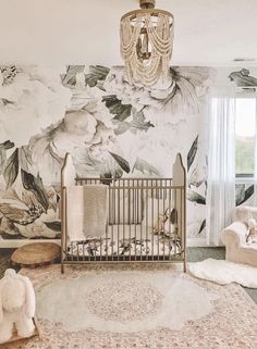 a baby's room with floral wallpaper and a crib