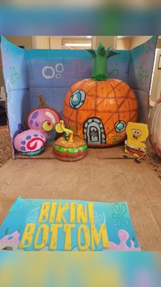 an inflatable pumpkin sitting on top of a floor next to other toys and decorations