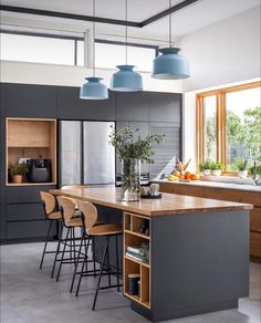 a kitchen with an island and chairs in it