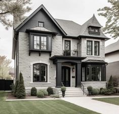 a large gray and white house with black trim