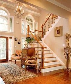 a living room filled with furniture and a stair case