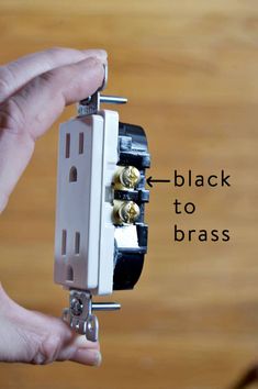 a person is holding an electrical device in their hand with the words black to brass on it