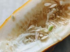 the inside of a melon with seeds on it