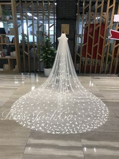 a white wedding veil is on display in the lobby