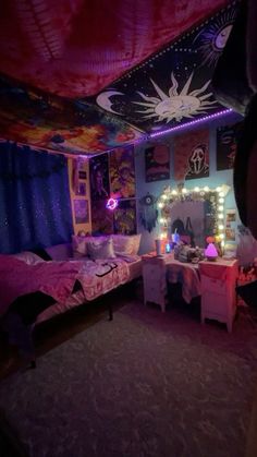 a bedroom decorated in purple and blue with lights on the ceiling, bedding and curtains